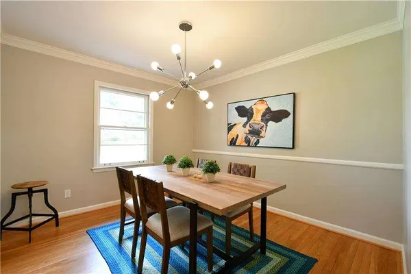 a view of a dining room with furniture wooden floor and chandelier
