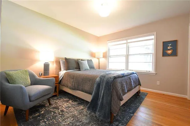 a spacious bedroom with a bed and window