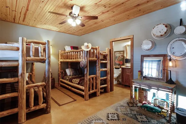 a living room with furniture a clock and a bookshelf