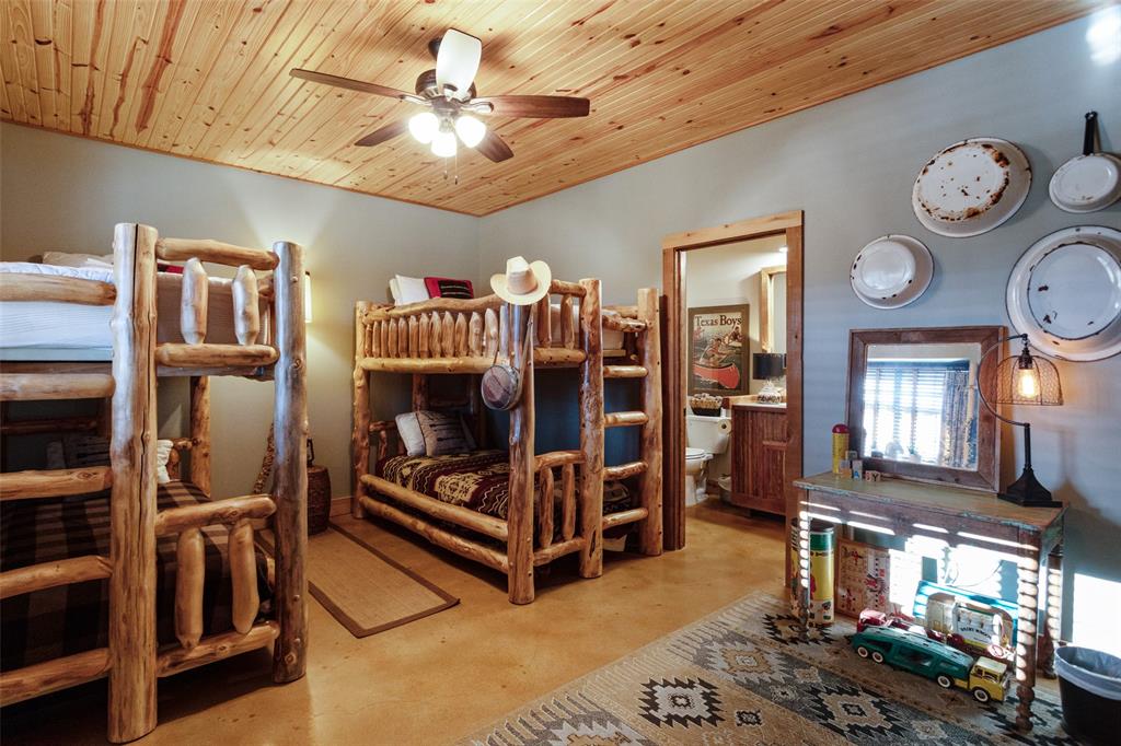 1016 Hells Gate Loop Strawn, TX 76475 - Photo 11 of 31 a living room with furniture a clock and a bookshelf