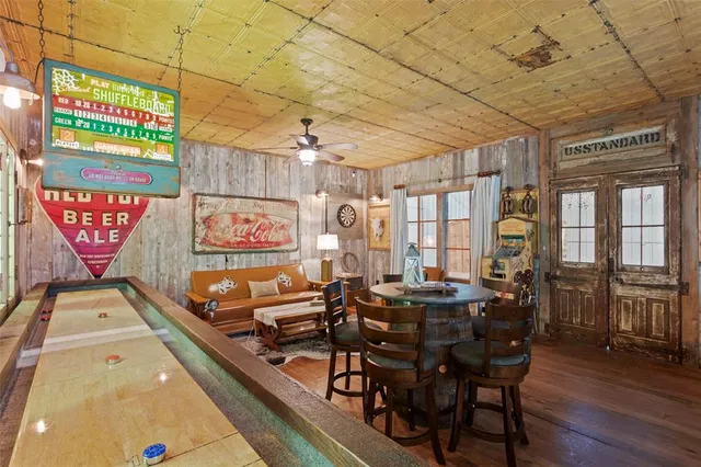 a view of a dining room with furniture a chandelier and wooden floor