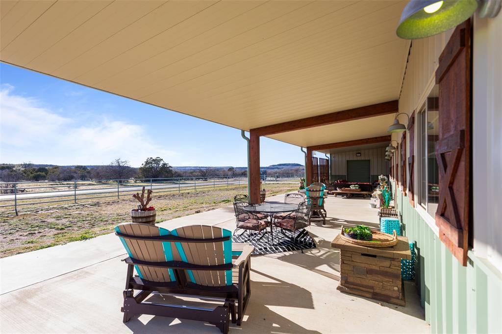 1016 Hells Gate Loop Strawn, TX 76475 - Photo 3 of 31 a view of a lake with couches and wooden floor