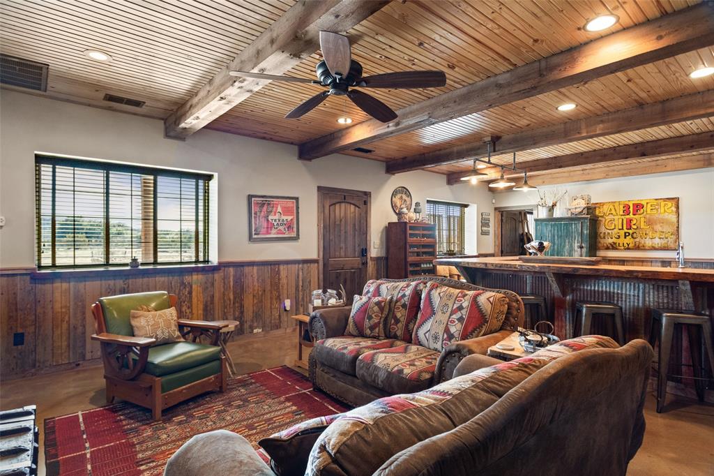 1016 Hells Gate Loop Strawn, TX 76475 - Photo 6 of 31 a living room with furniture a ceiling fan and a rug