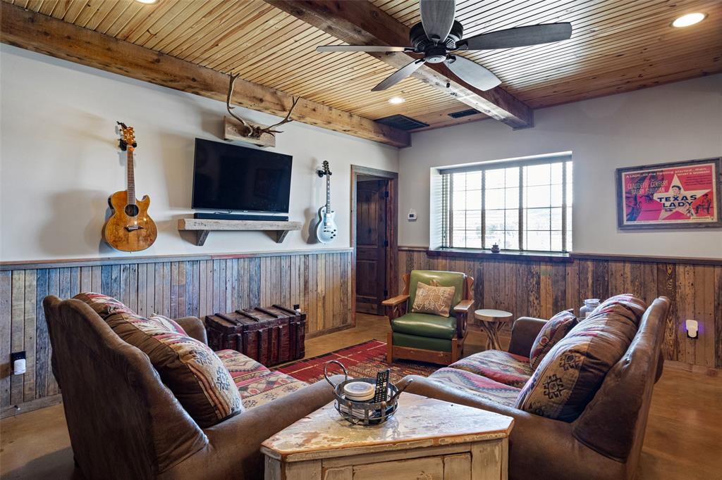 1016 Hells Gate Loop Strawn, TX 76475 - Photo 7 of 31 a living room with furniture a flat screen tv and kitchen view