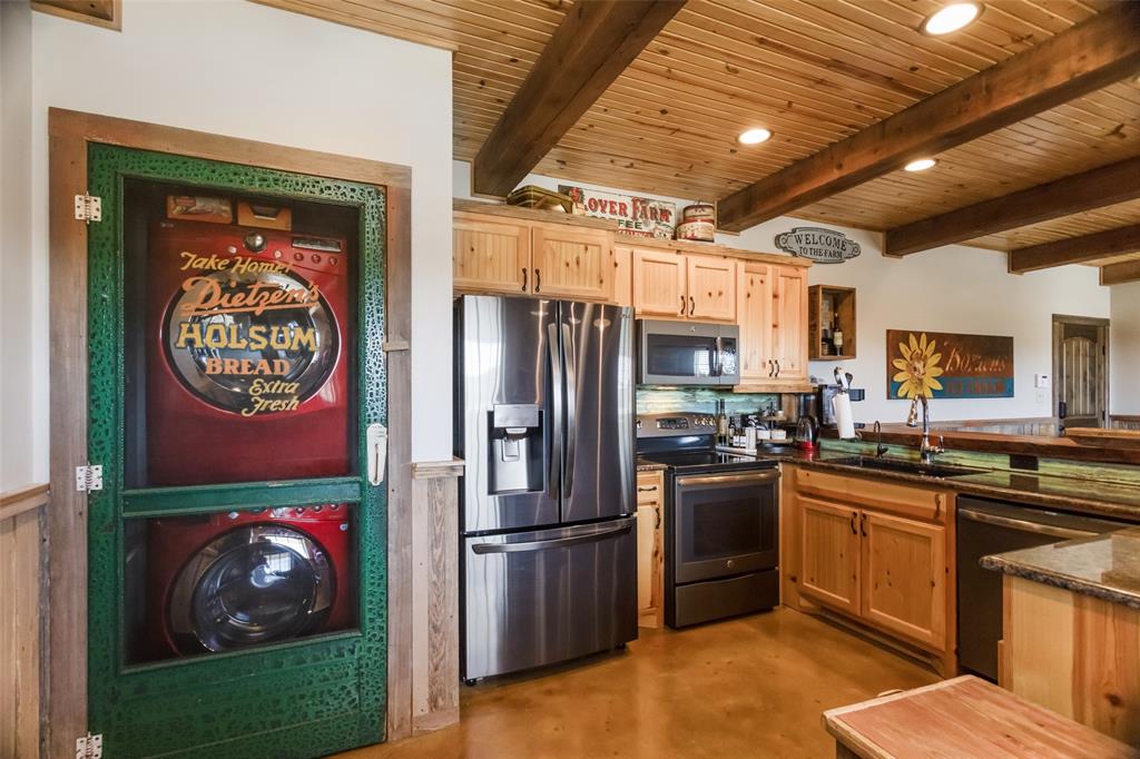 1016 Hells Gate Loop Strawn, TX 76475 - Photo 9 of 31 a kitchen with stainless steel appliances granite countertop a refrigerator a stove and a sink
