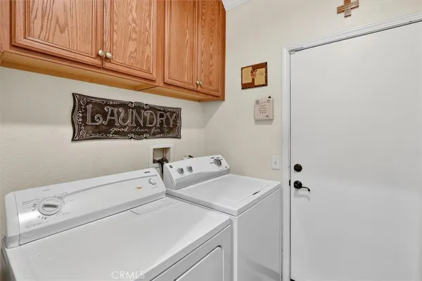 a kitchen with a stove and a flat screen tv