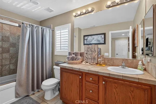 a bedroom with a bed and ceiling fan