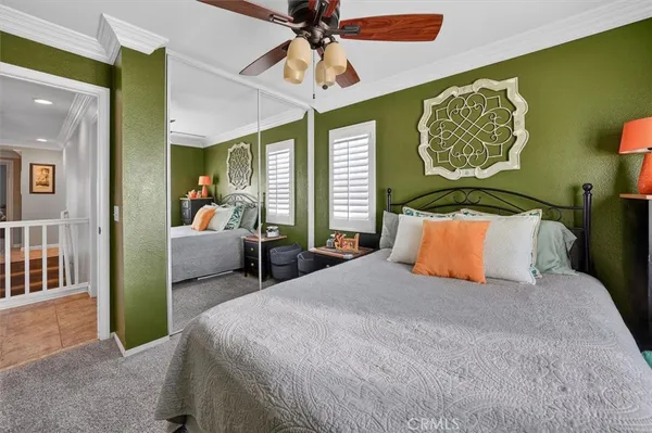 a bedroom with a bed and flat screen tv