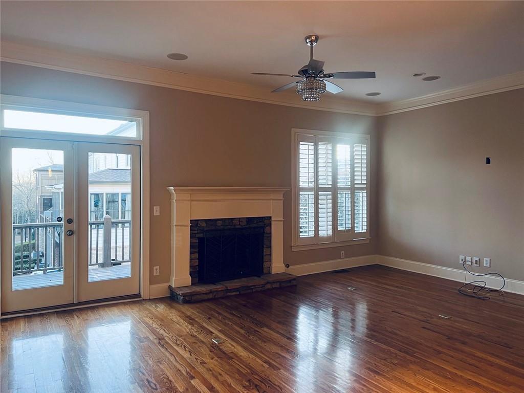 144 West Ridge Way Roswell, GA 30076 - Photo 12 of 30 a view of an empty room with wooden floor fireplace and a window