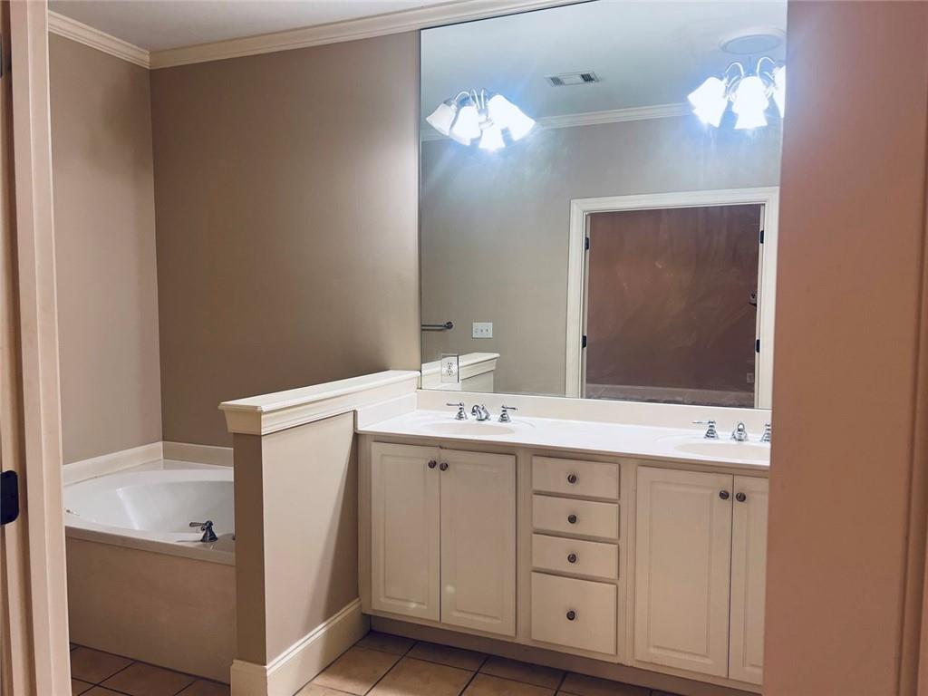144 West Ridge Way Roswell, GA 30076 - Photo 24 of 30 a bathroom with a sink a vanity and a mirror