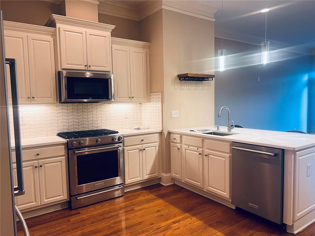 144 West Ridge Way Roswell, GA 30076 - Photo 6 of 30 a kitchen with stainless steel appliances granite countertop a stove a sink and a microwave