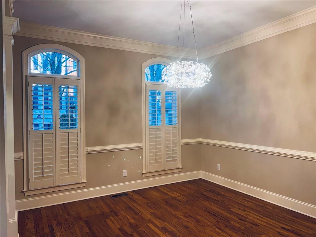 144 West Ridge Way Roswell, GA 30076 - Photo 8 of 30 an empty room with wooden floor chandelier and entryway