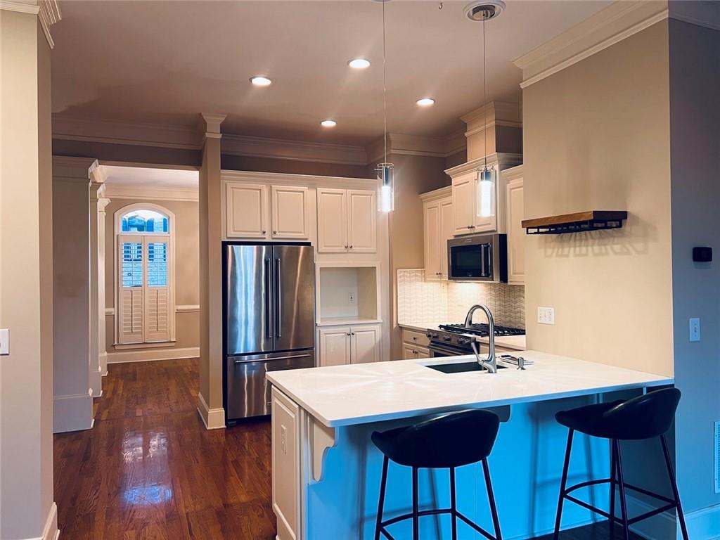 144 West Ridge Way Roswell, GA 30076 - Photo 10 of 30 a kitchen with stainless steel appliances a refrigerator and a stove top oven