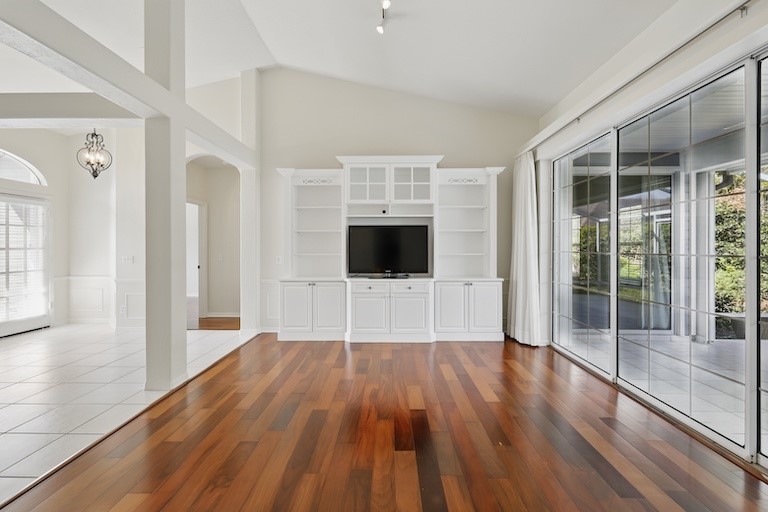 wooden floor in an empty room with a window