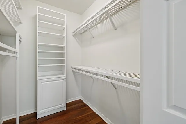 a view of walk in closet with empty racks