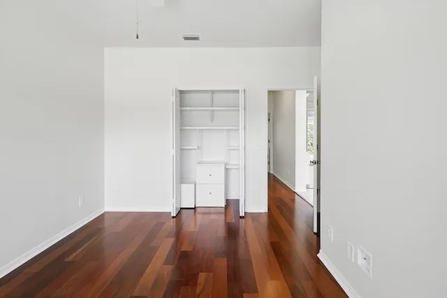 a view of a room with wooden floor
