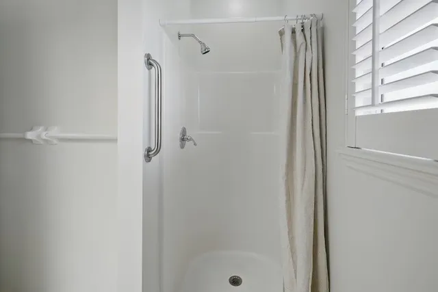 a bathroom with a glass shower door