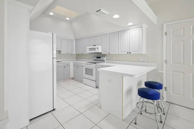 a kitchen with stainless steel appliances granite countertop a sink and a refrigerator