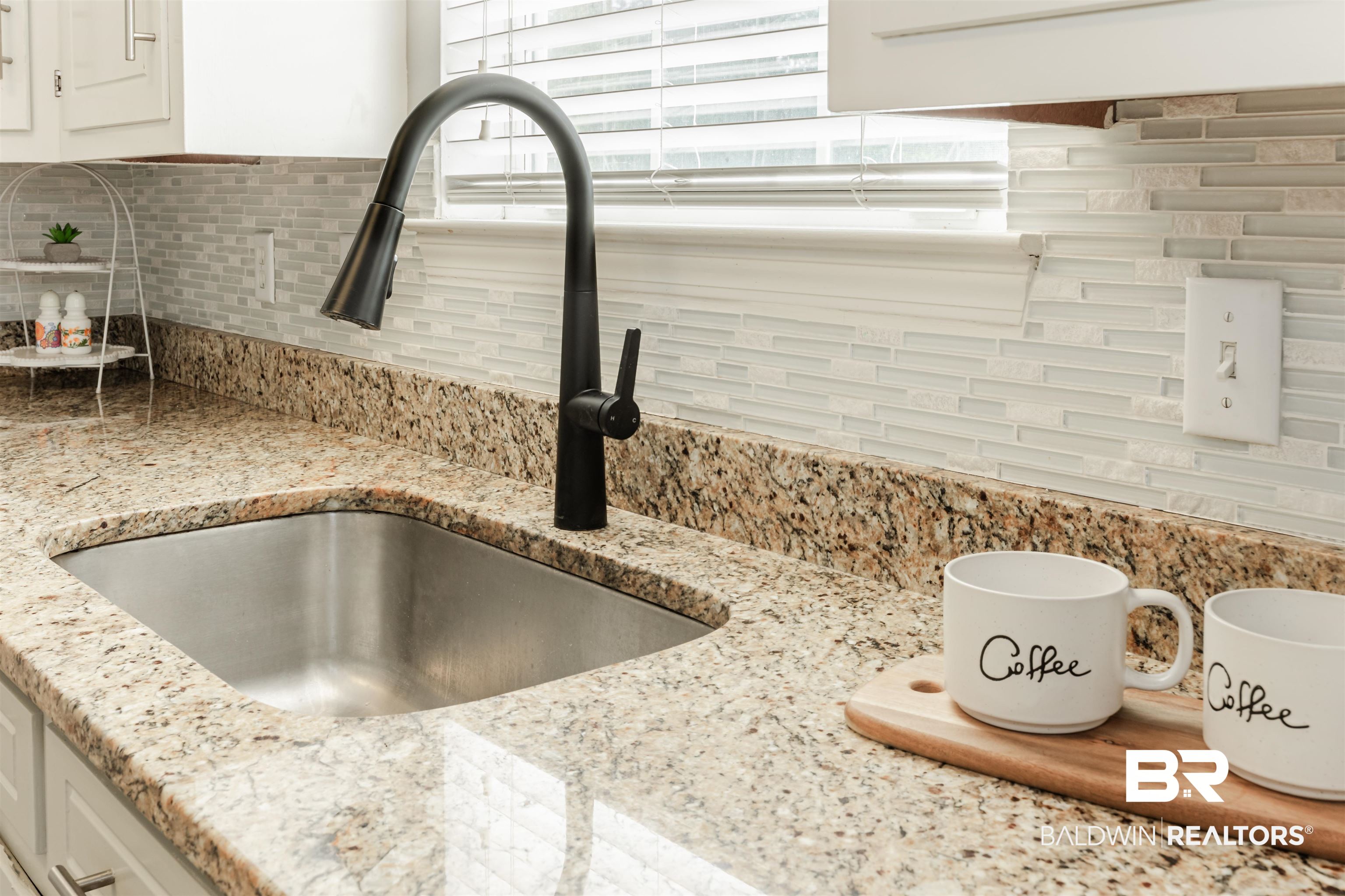 3844 Isabel Way South Mobile, AL 36693 - Photo 12 of 49 Interior details featuring white cabinetry, light stone countertops, sink, and backsplash