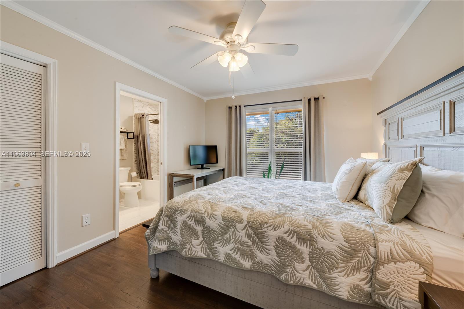 3197 Virginia Street Miami, FL 33133 - Photo 16 of 22 a bedroom with a bed and a large window