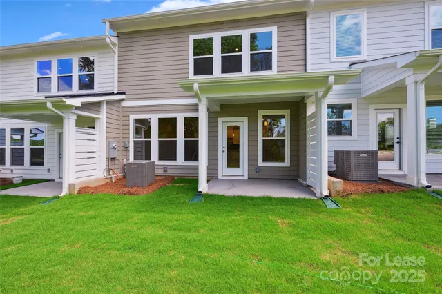 a view of a house with a yard and a large window