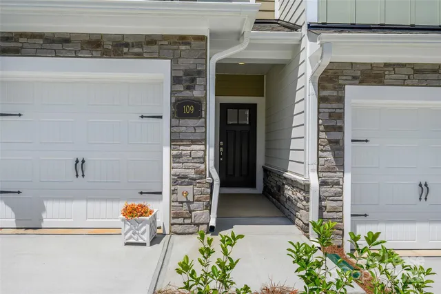 a view of front door of house with potted plant