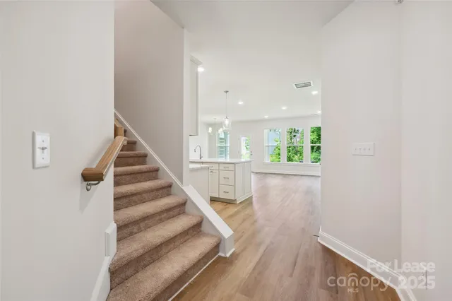 a view of entryway and hall with wooden floor