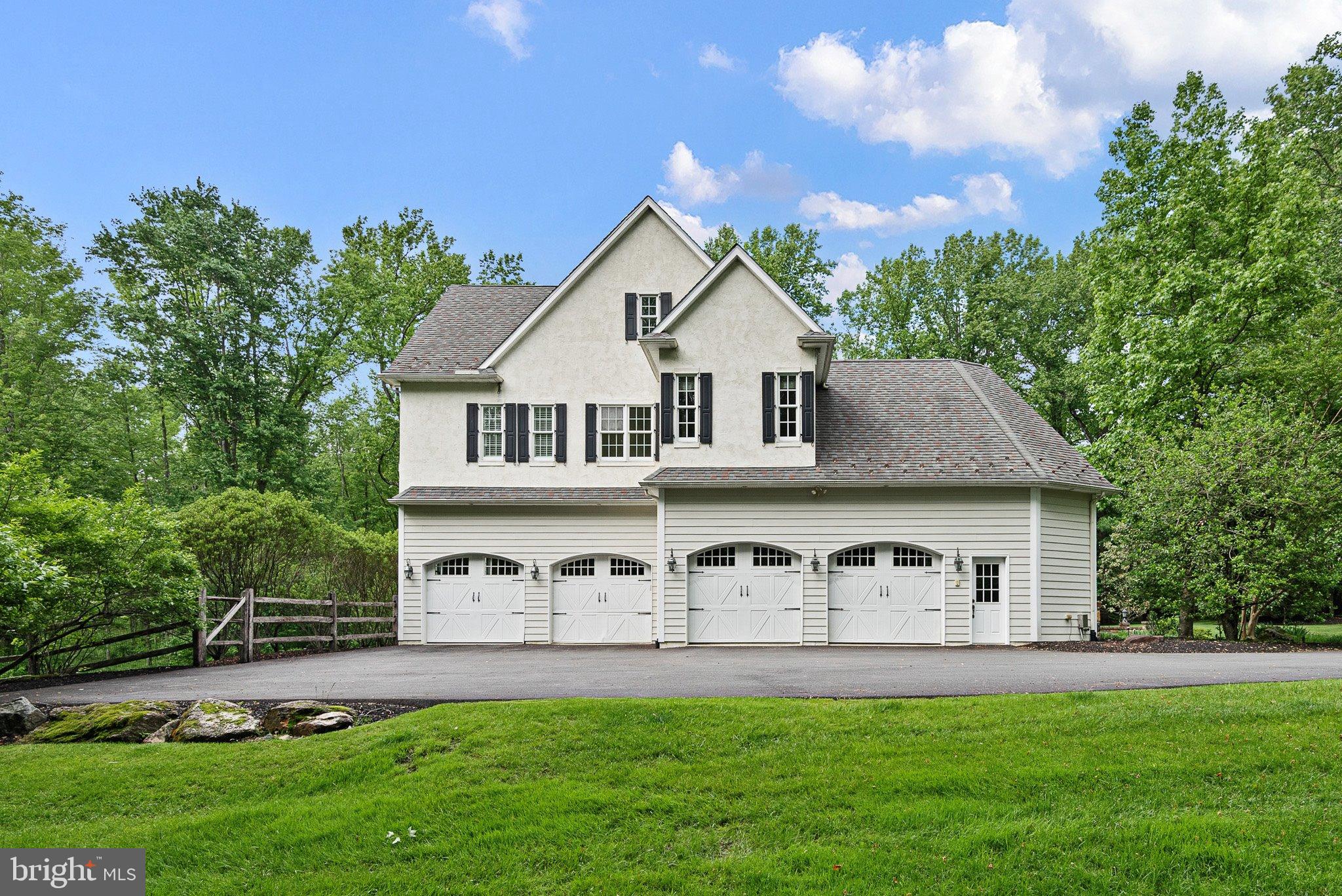 104 Timber Ridge Lane Chadds Ford, PA 19317 - Photo 65 of 65 a front view of a house with a yard and garage