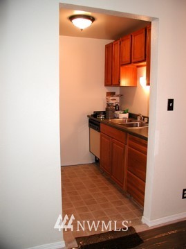 412 Mill Avenue South Renton, WA 98057 - Photo 6 of 13 a kitchen with granite countertop a sink and a stove