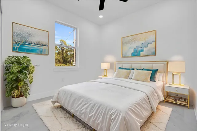 a bedroom with a bed and a painting on the wall