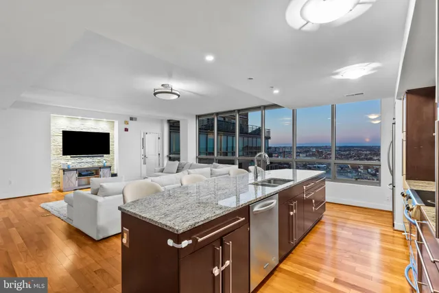 a large kitchen with sink and a large window