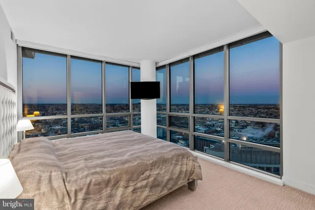 a large bedroom with a bed and a view of closet