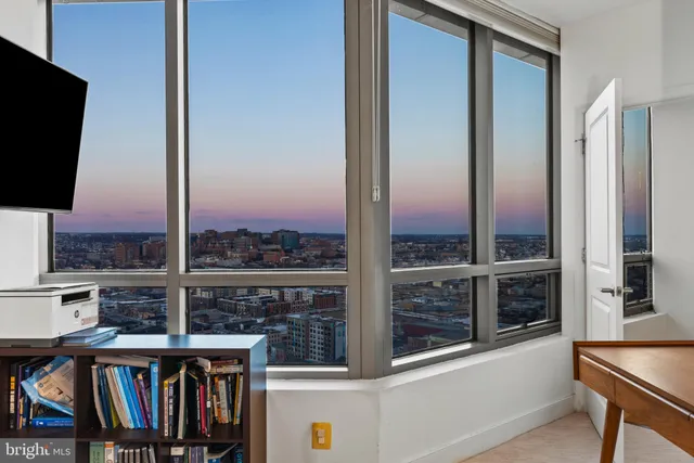 a view of a balcony with furniture and front door