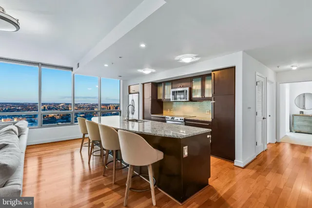 a kitchen with kitchen island granite countertop a table and chairs