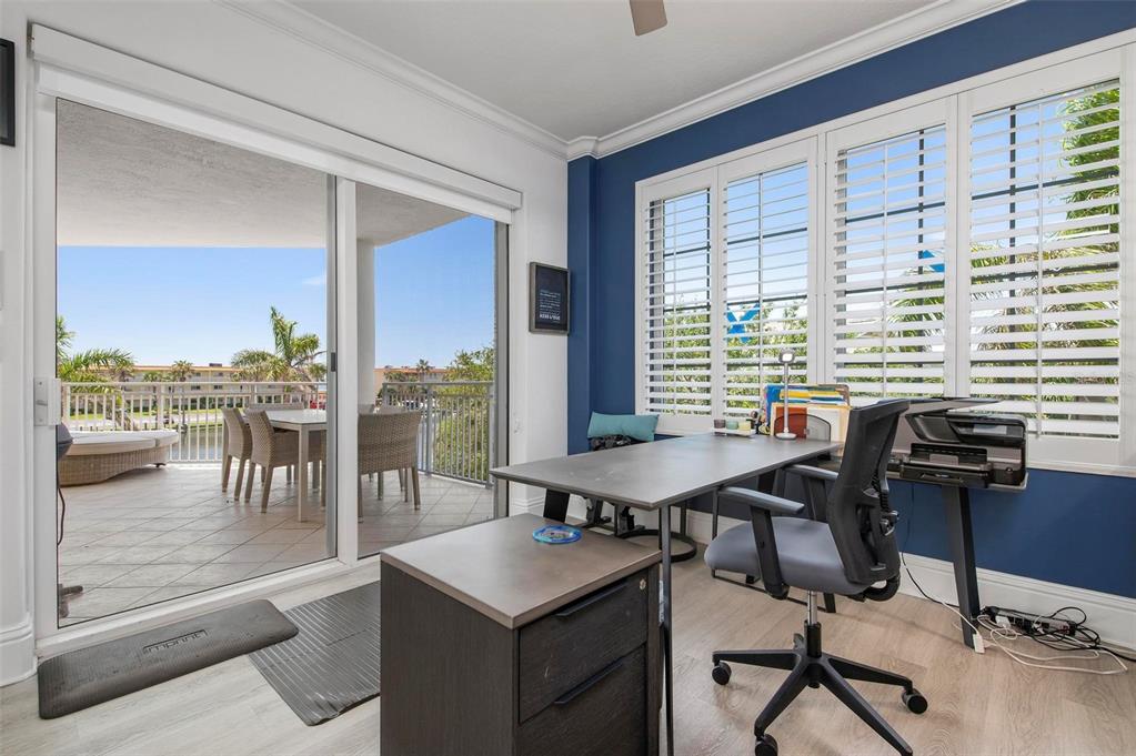 9122 Midnight Pass Road, Unit 34 Sarasota, FL 34242 - Photo 12 of 61 a view of a workspace with furniture and a large window