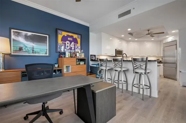 a kitchen with stainless steel appliances granite countertop a stove a sink and a white cabinets