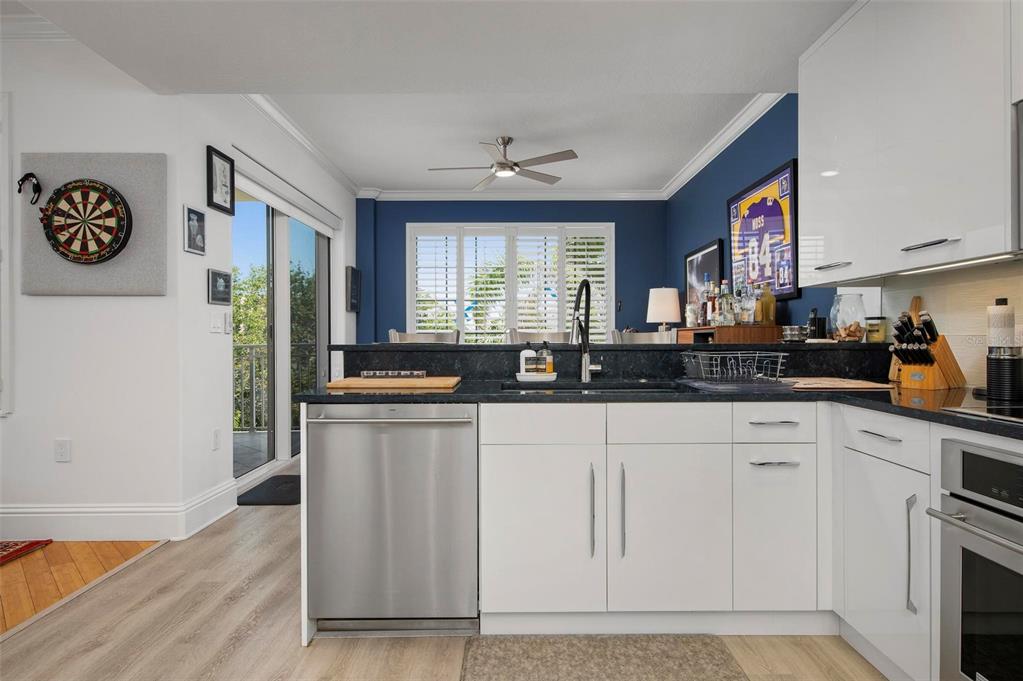 9122 Midnight Pass Road, Unit 34 Sarasota, FL 34242 - Photo 17 of 61 a kitchen with stainless steel appliances granite countertop a stove a sink and a refrigerator
