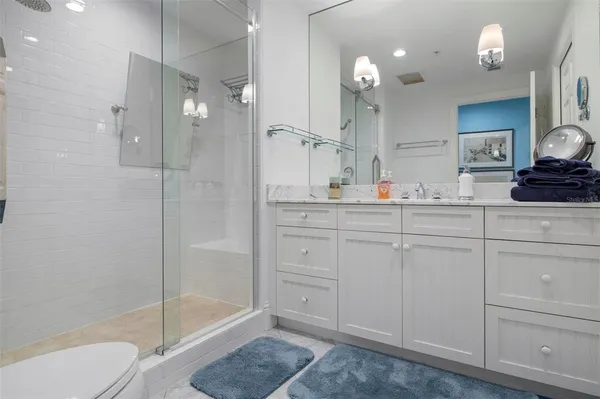 a bedroom with a bed and glass door