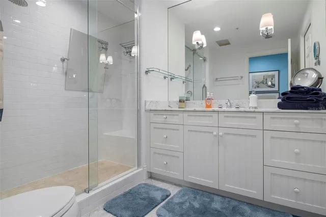 a bedroom with a bed and glass door