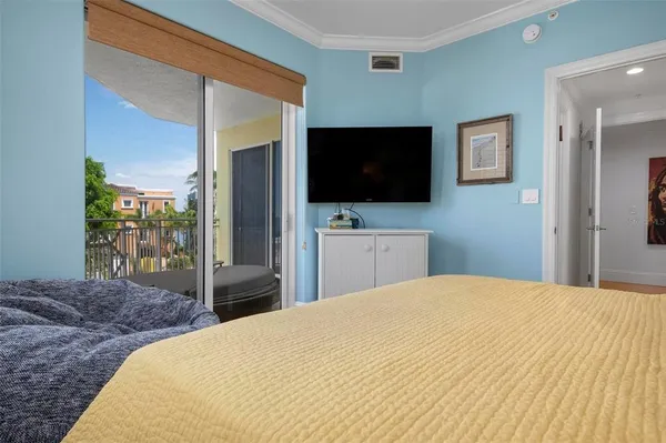 a bedroom with a bed and a flat screen television