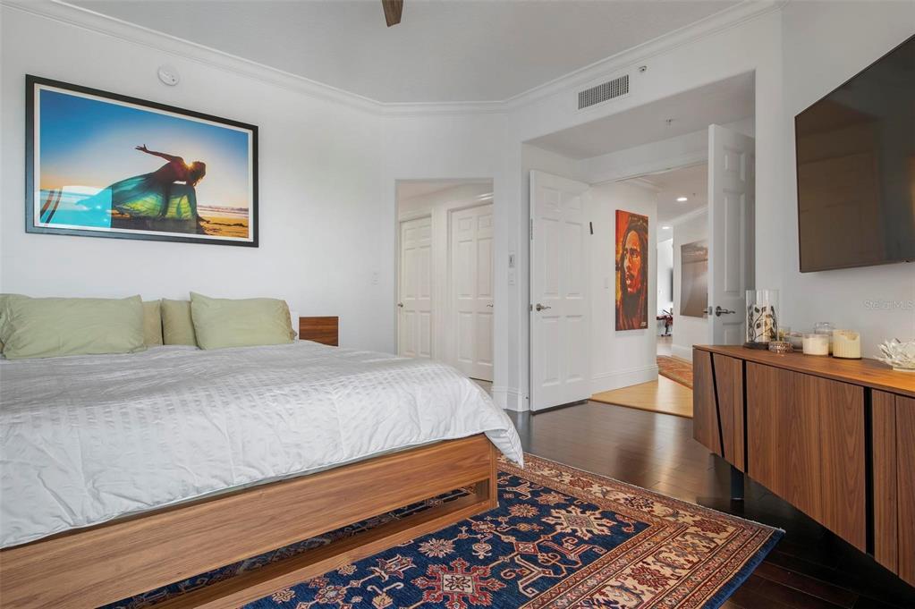 9122 Midnight Pass Road, Unit 34 Sarasota, FL 34242 - Photo 29 of 61 a bedroom with a bed and a flat screen television