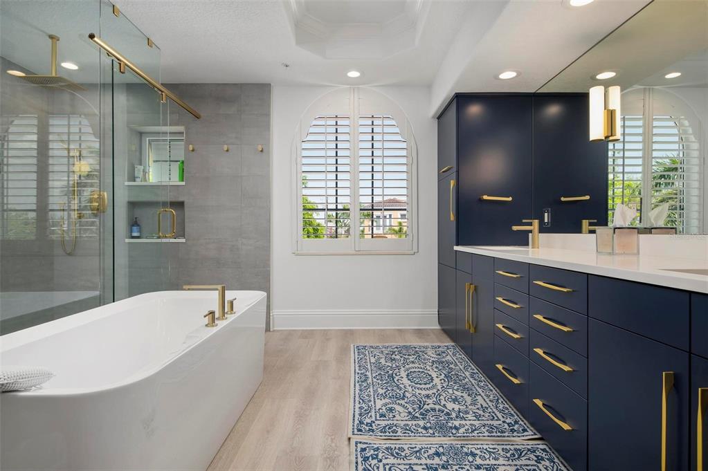 9122 Midnight Pass Road, Unit 34 Sarasota, FL 34242 - Photo 31 of 61 a bathroom with a bathtub sink and mirror