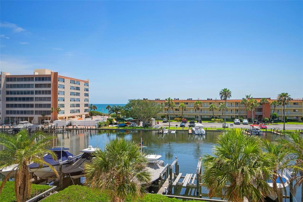 9122 Midnight Pass Road, Unit 34 Sarasota, FL 34242 - Photo 34 of 61 a view of a lake with building in front of it