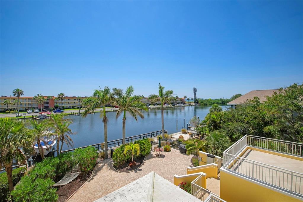 9122 Midnight Pass Road, Unit 34 Sarasota, FL 34242 - Photo 35 of 61 a view of a backyard with plants and a patio