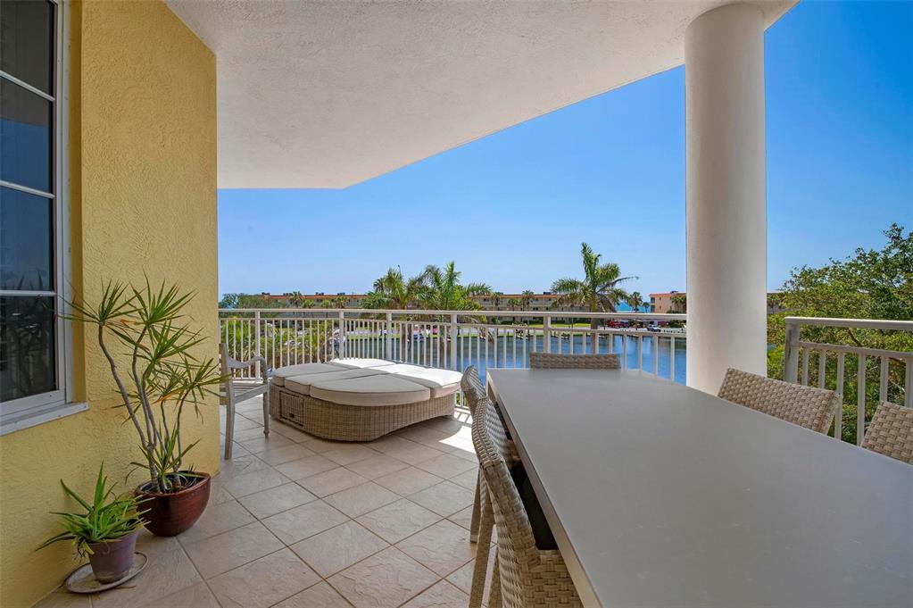 9122 Midnight Pass Road, Unit 34 Sarasota, FL 34242 - Photo 38 of 61 a balcony with furniture and a potted plant