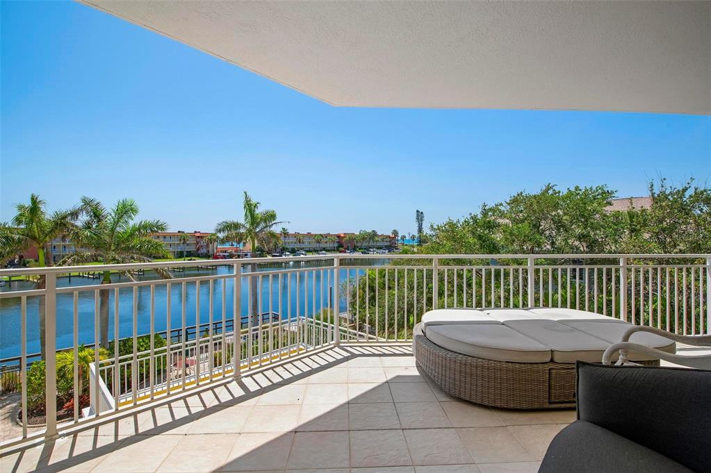 9122 Midnight Pass Road, Unit 34 Sarasota, FL 34242 - Photo 40 of 61 a view of a roof deck with couches and wooden floor