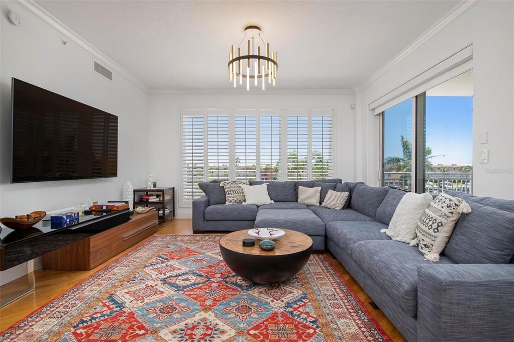 9122 Midnight Pass Road, Unit 34 Sarasota, FL 34242 - Photo 4 of 61 a living room with furniture and a flat screen tv