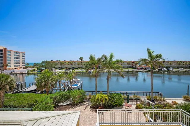 a swimming pool with outdoor seating and yard in back