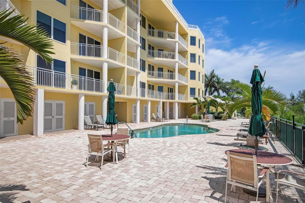 9122 Midnight Pass Road, Unit 34 Sarasota, FL 34242 - Photo 44 of 61 a building outdoor space with patio furniture and potted plants