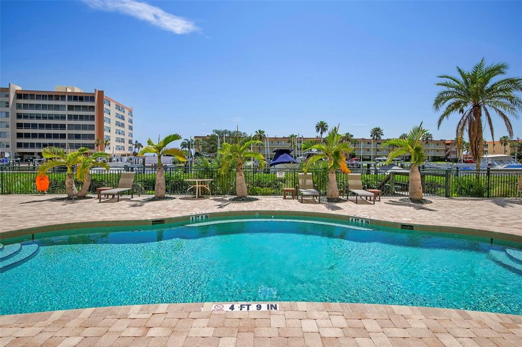 9122 Midnight Pass Road, Unit 34 Sarasota, FL 34242 - Photo 46 of 61 a view of swimming pool with outdoor seating and plants